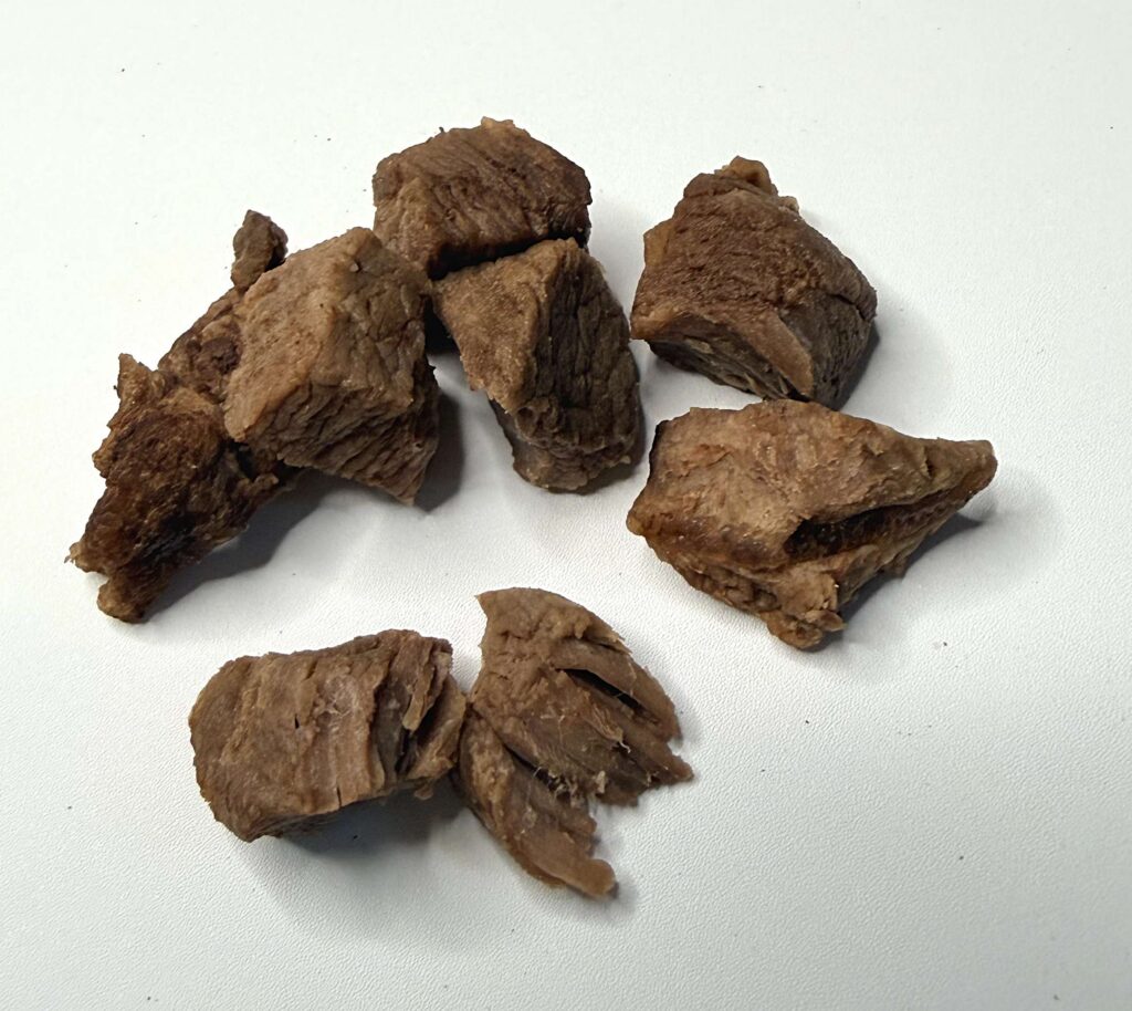 Dunkelbraune gefriergetrocknete und rehydrierte Hirschstücke als Monoprotein Leckerli für Hunde
